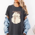 Pepper Comfort Colors graphic tee with a vintage-style illustration of a woman riding a bicycle down an open path and the phrase “Everything is Temporary.”