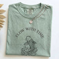 Folded Bay Comfort Colors t-shirt with the Flow With Time koi fish design and necklace styling