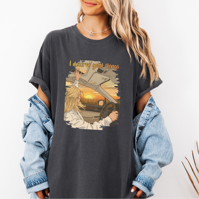 Pepper Comfort Colors graphic tee with a colorful sunset driving illustration and the phrase “I deserve good things.”
