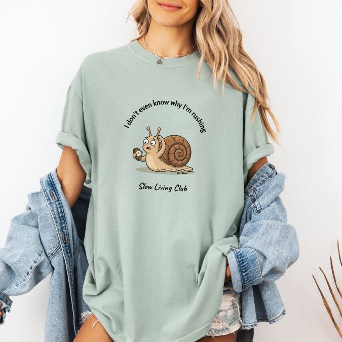 Bay green Comfort Colors tee featuring a confused snail with a clock and I Don’t Even Know Why I’m Rushing text.