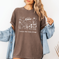 Espresso Comfort Colors graphic tee with a blue camp doodle illustration featuring outdoor icons and the phrase “I enjoy the little things”