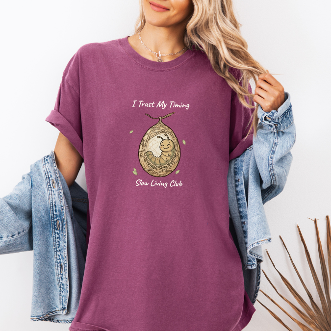 Berry slow living shirt with I Trust My Timing phrase and cocoon caterpillar graphic.
