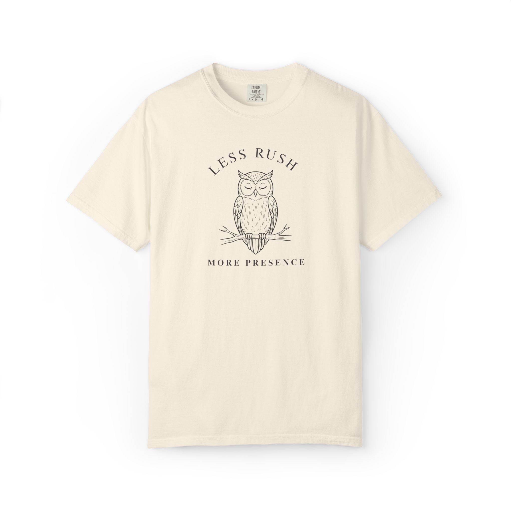Front view of an ivory Comfort Colors T-shirt with minimalist owl and Less Rush More Presence quote