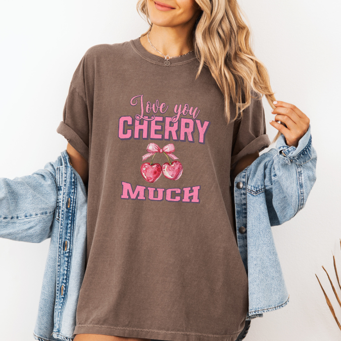 Espresso Comfort Colors graphic tee with pink lettering, heart-shaped cherries with a bow, and the phrase “Love You Cherry Much.”