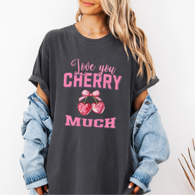 Pepper Comfort Colors graphic tee with pink lettering, heart-shaped cherries with a bow, and the phrase “Love You Cherry Much.”