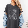 Pepper Comfort Colors graphic tee with a feminine line art illustration of a woman holding a dandelion and the phrase “Make a Wish”