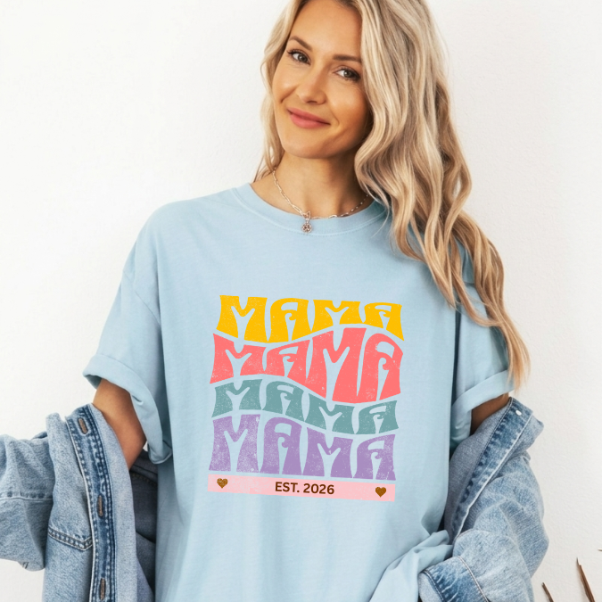 Chambray Comfort Colors t-shirt with bold retro stacked MAMA lettering in yellow, pink, teal, and purple plus a customizable EST. year design for new moms