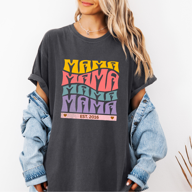 Pepper Comfort Colors t-shirt with bold retro stacked MAMA lettering in yellow, pink, teal, and purple plus a customizable EST. year design for new moms