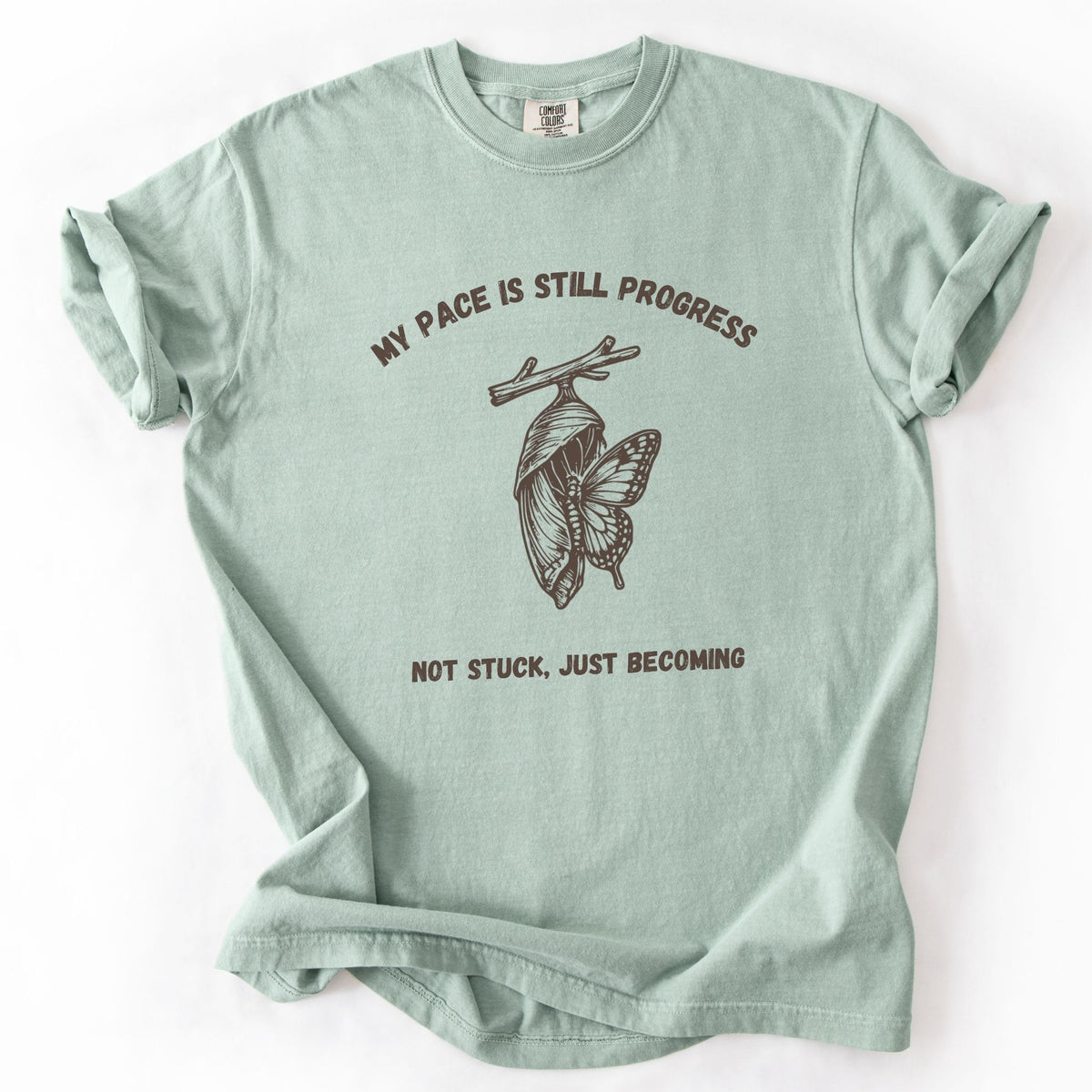 My Pace Is Still Progress chrysalis Comfort Colors tee in Bay green, flat lay product photo