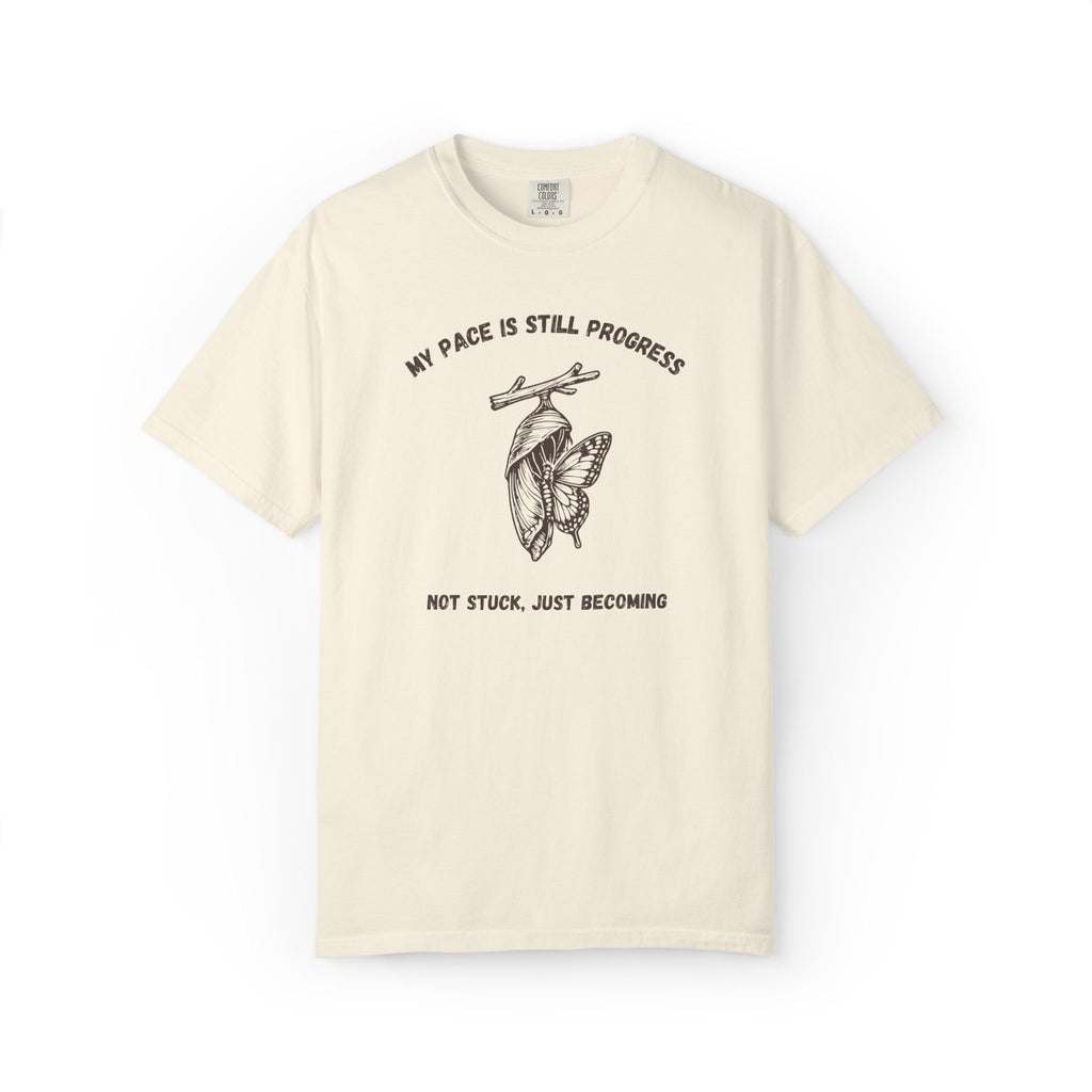 My Pace Is Still Progress chrysalis Comfort Colors tee in Ivory, folded flat lay product photo