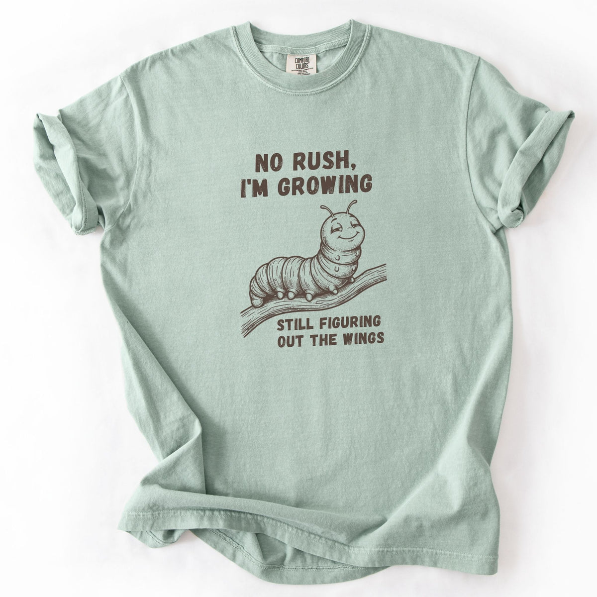No Rush I'm Growing caterpillar Comfort Colors tee in Bay green, flat lay product photo