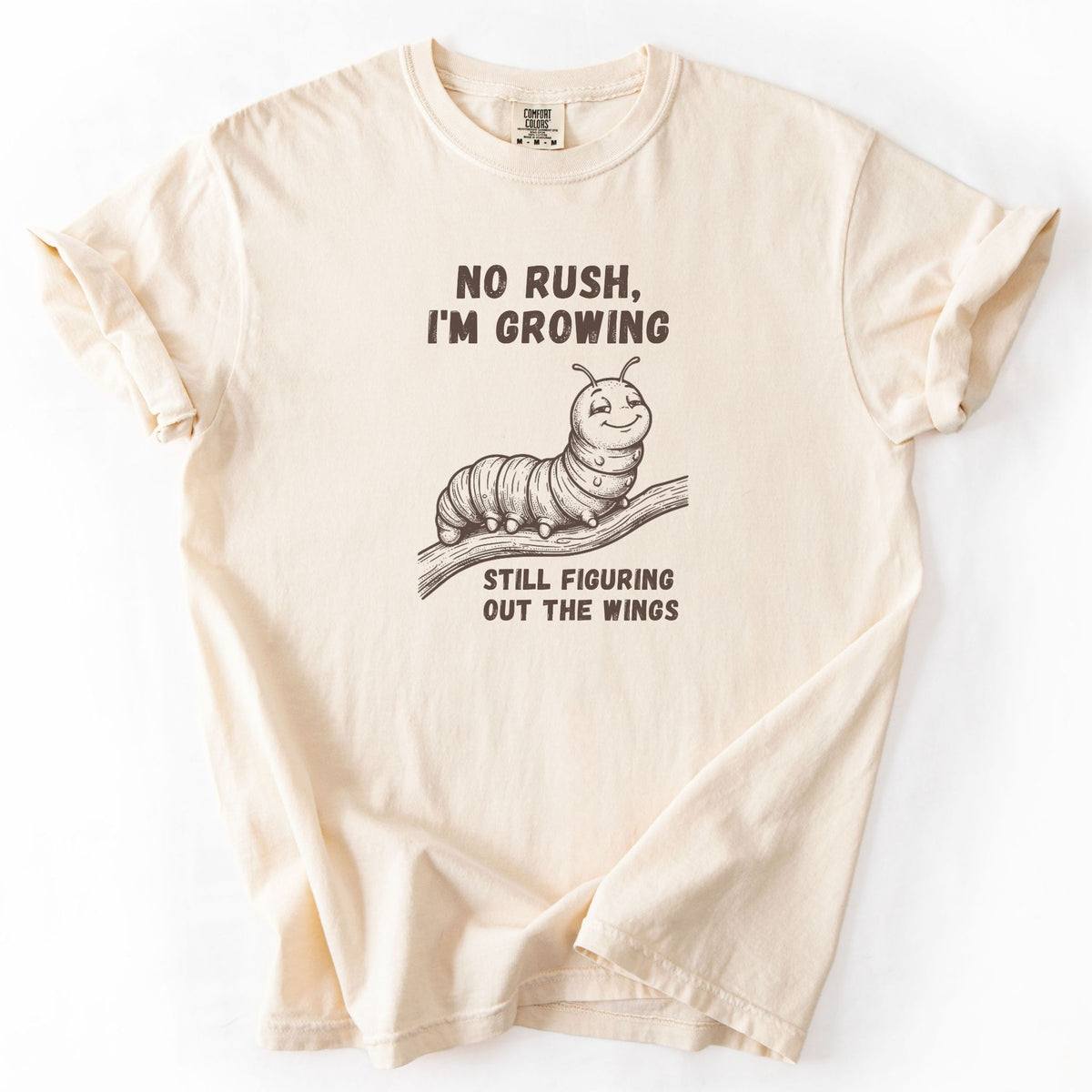 No Rush I'm Growing caterpillar Comfort Colors tee in Ivory, folded flat lay product photo