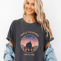Charcoal Comfort Colors graphic tee with a circular sunset scene of two people sitting together on a bench and the phrase “Simple Pleasures Side by Side.”