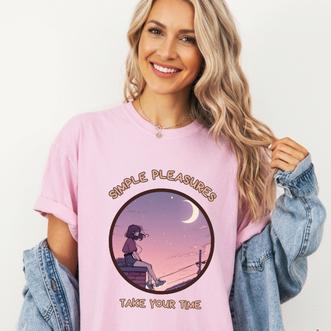 Pink Comfort Colors graphic tee with a circular moonlit scene of a girl sitting quietly and the phrase “Simple Pleasures Take Your Time.”