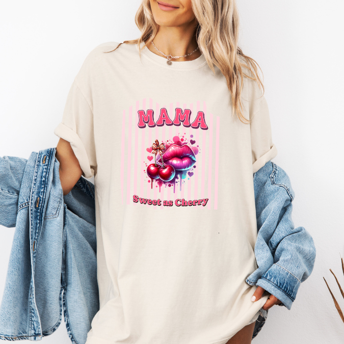Ivory Comfort Colors graphic tee with bold pink MAMA lettering, cherries, lips, and the phrase “Sweet as Cherry.”