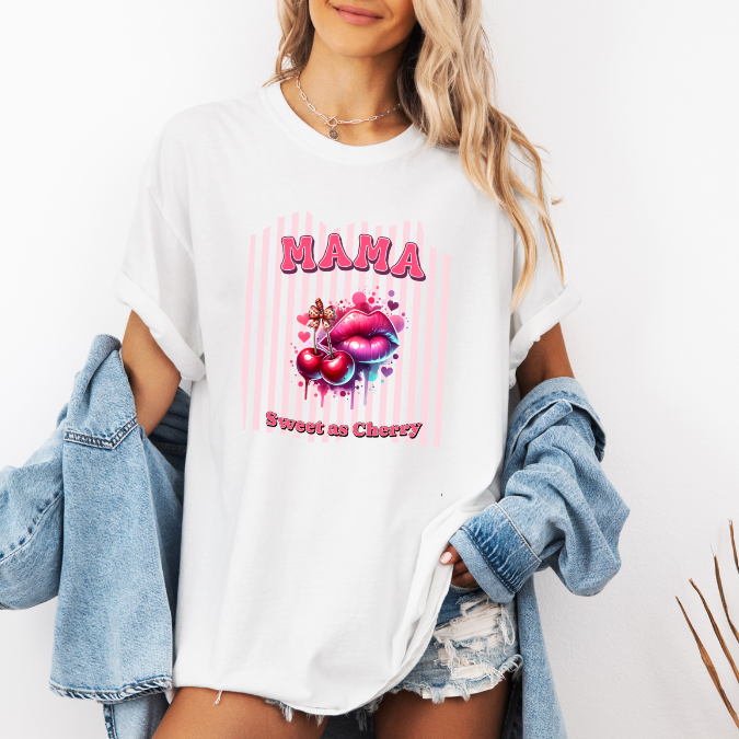 White Comfort Colors graphic tee with bold pink MAMA lettering, cherries, lips, and the phrase “Sweet as Cherry.”
