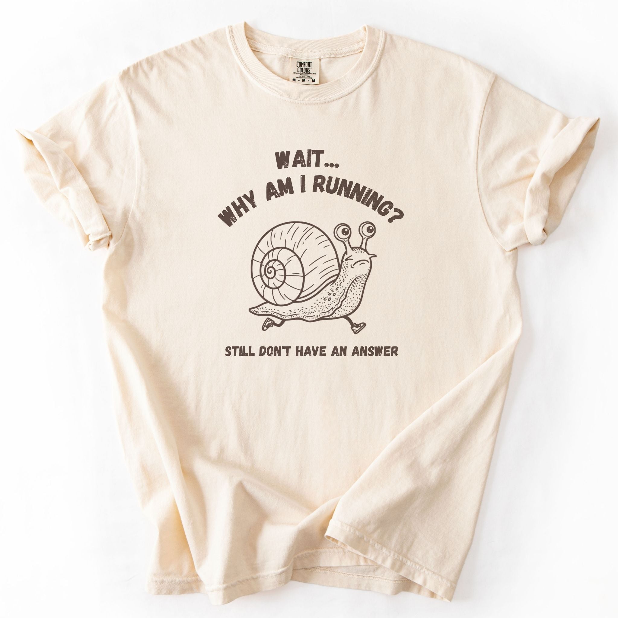 Wait Why Am I Running snail Comfort Colors tee in Ivory, flat lay product photo